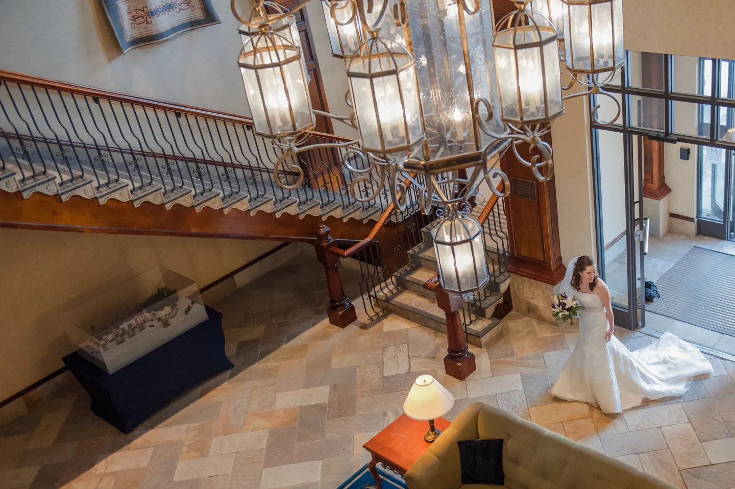 An aerial view of a bride walking through a grand hotel lobby