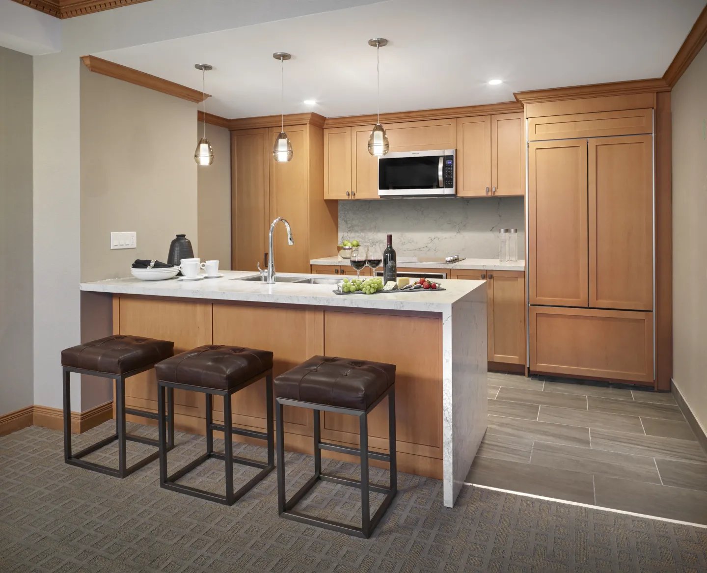 Full sized kitchen with oven and stovetop, full fridge, dishwasher, and kitchenware