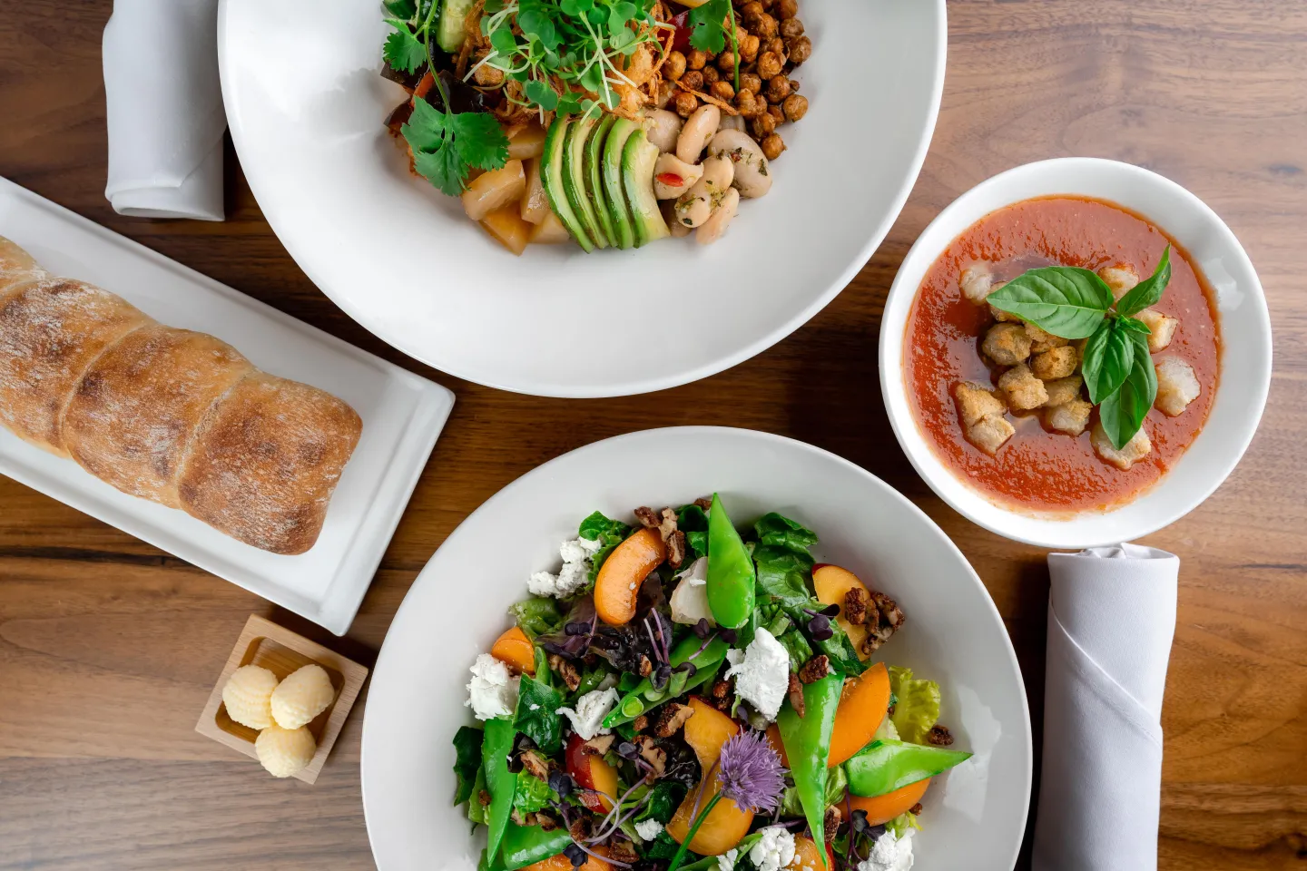 Aerial food shot of salads, soup and bread