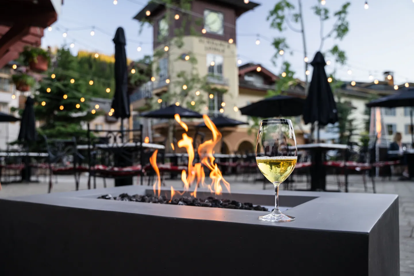 A glass of wine on an outdoor patio fireplace