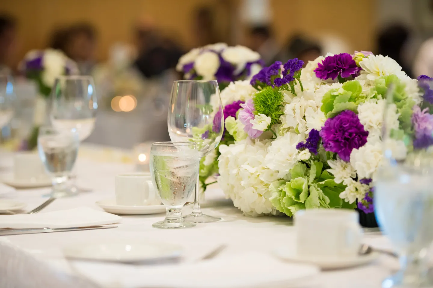 An event table setting with white tablewear and flowers
