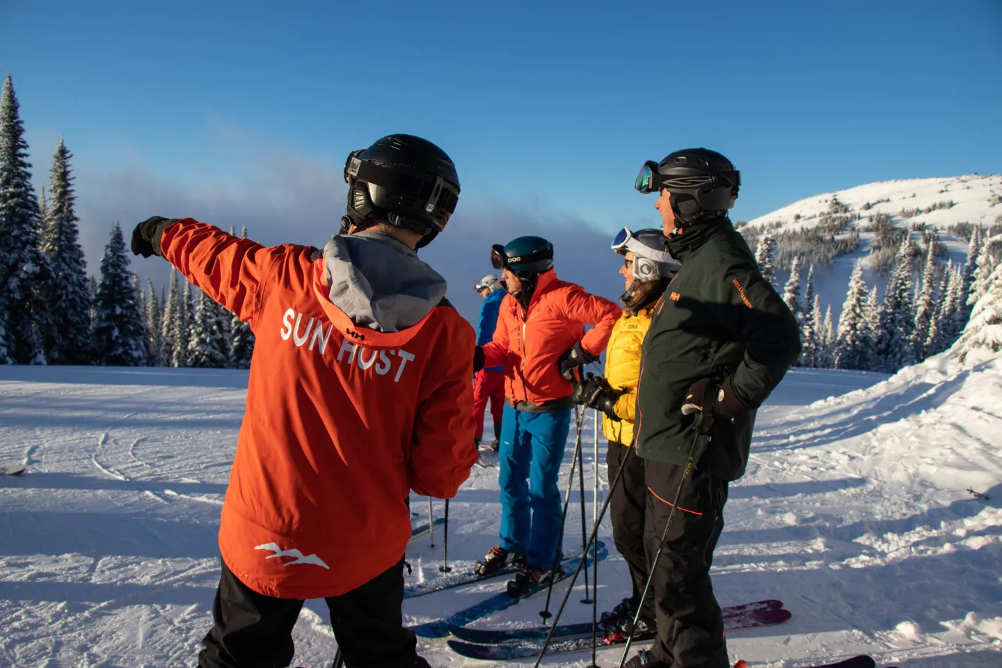 Sunhost and skiers on the mountain