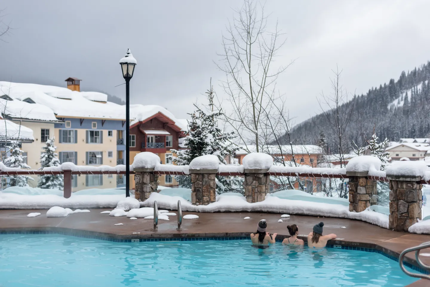 Three women in the pool with mountain views