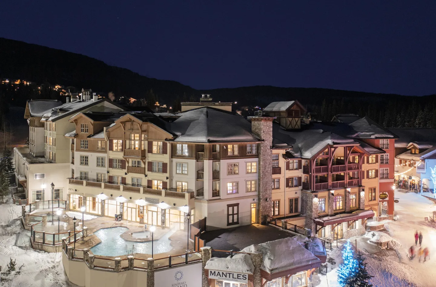 Hotel exterior with pool and village views