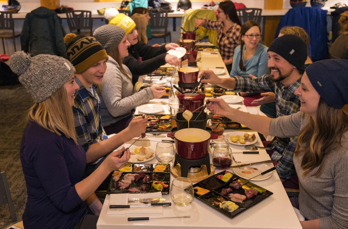 People at a table eating fondue