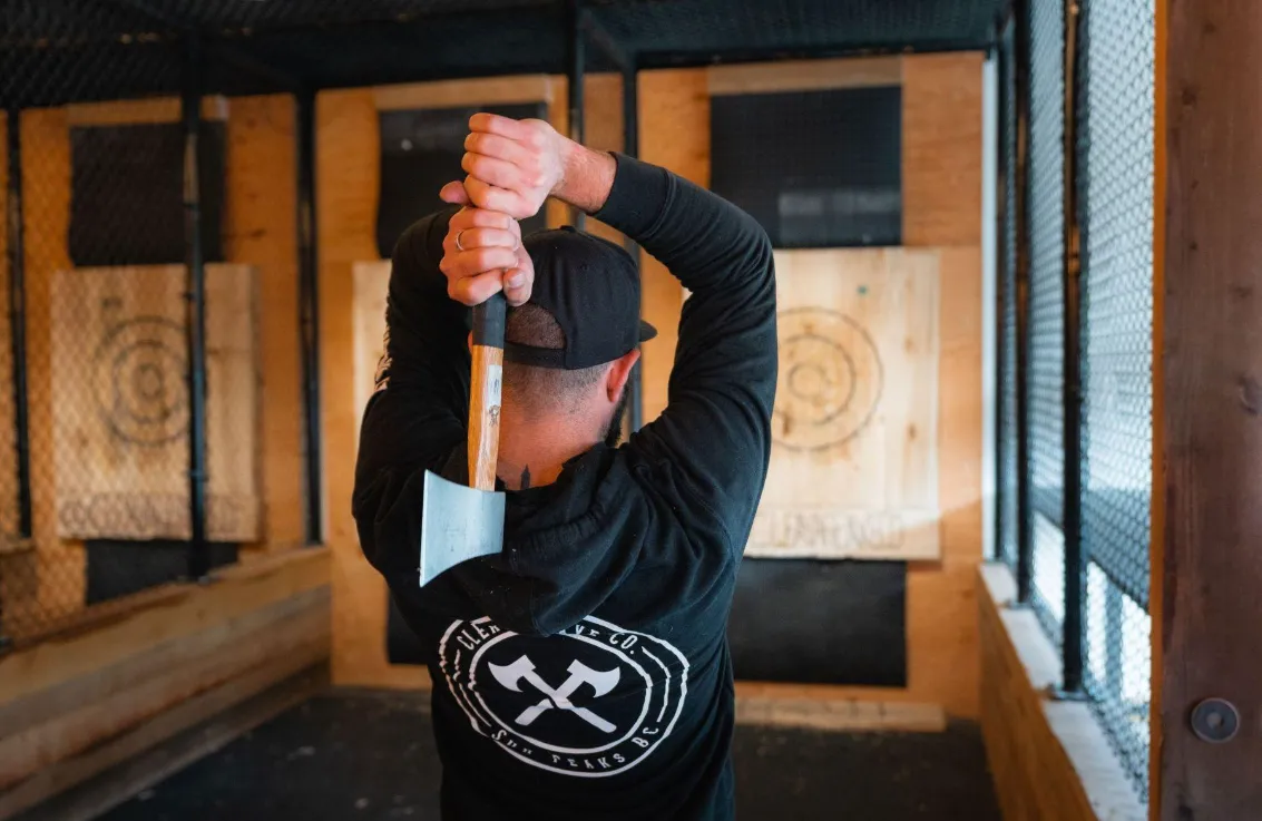 A man throwing an axe towards a target