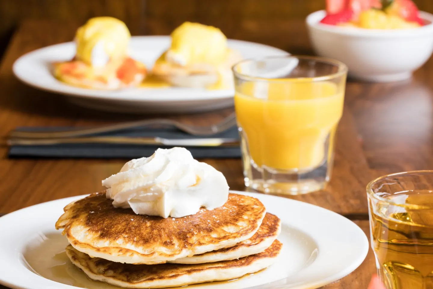 Breakfast foods plated on a wooden table