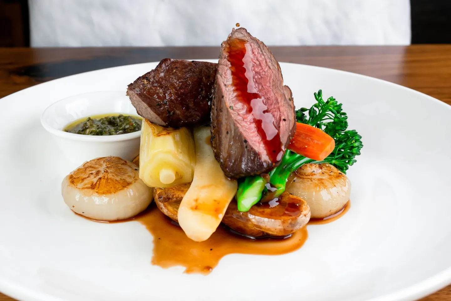 Plated steak with vegetables and scallops
