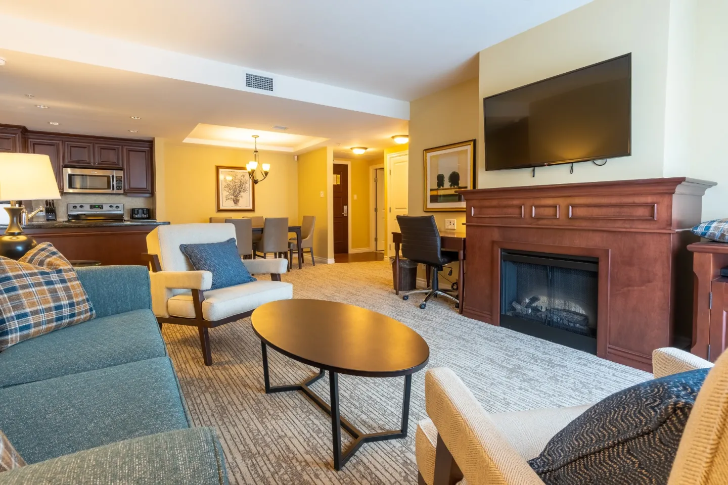 Photo of the inside of a hotel room with a living area and kitchen