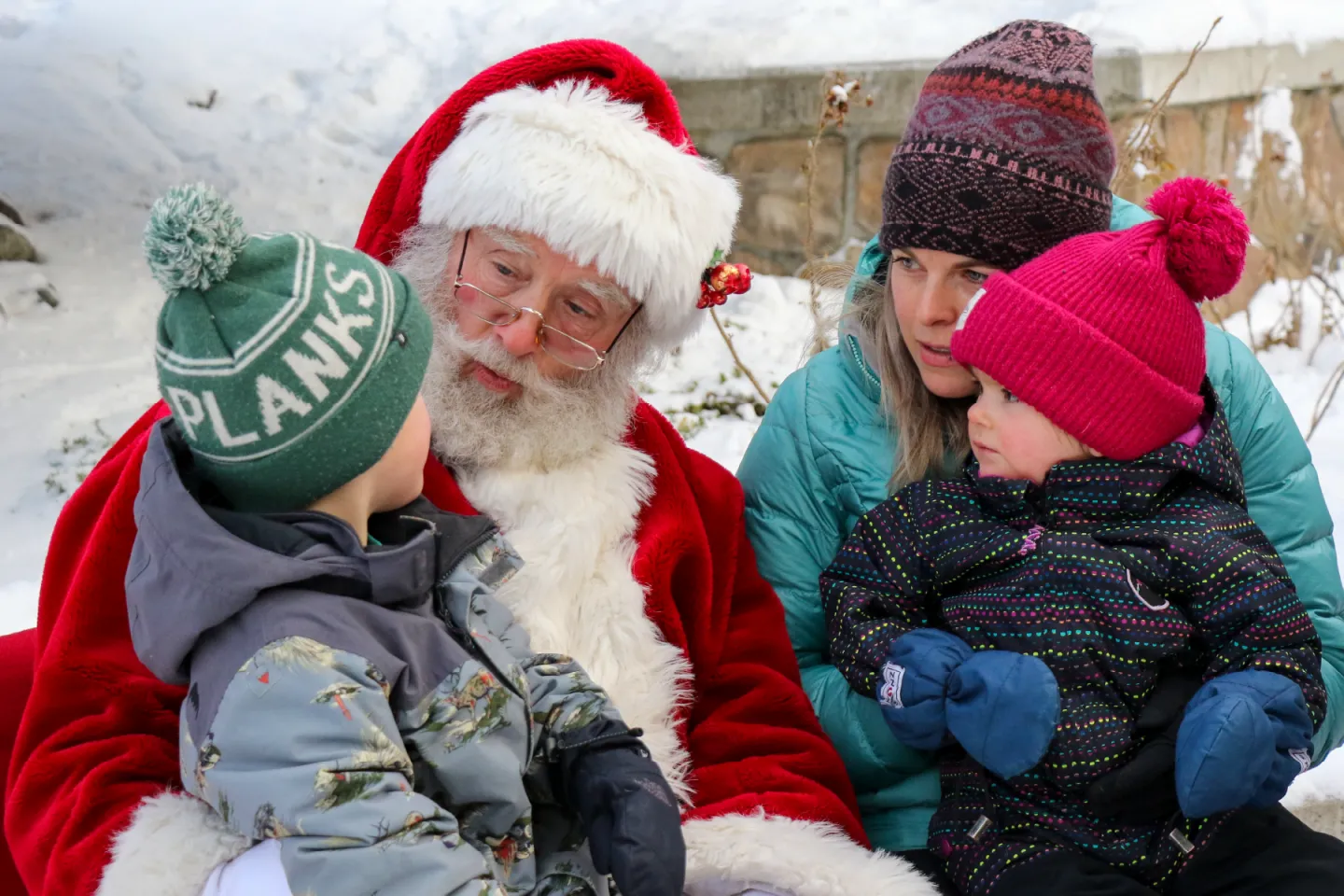 Kids sitting on Santa's lap outside in the winter