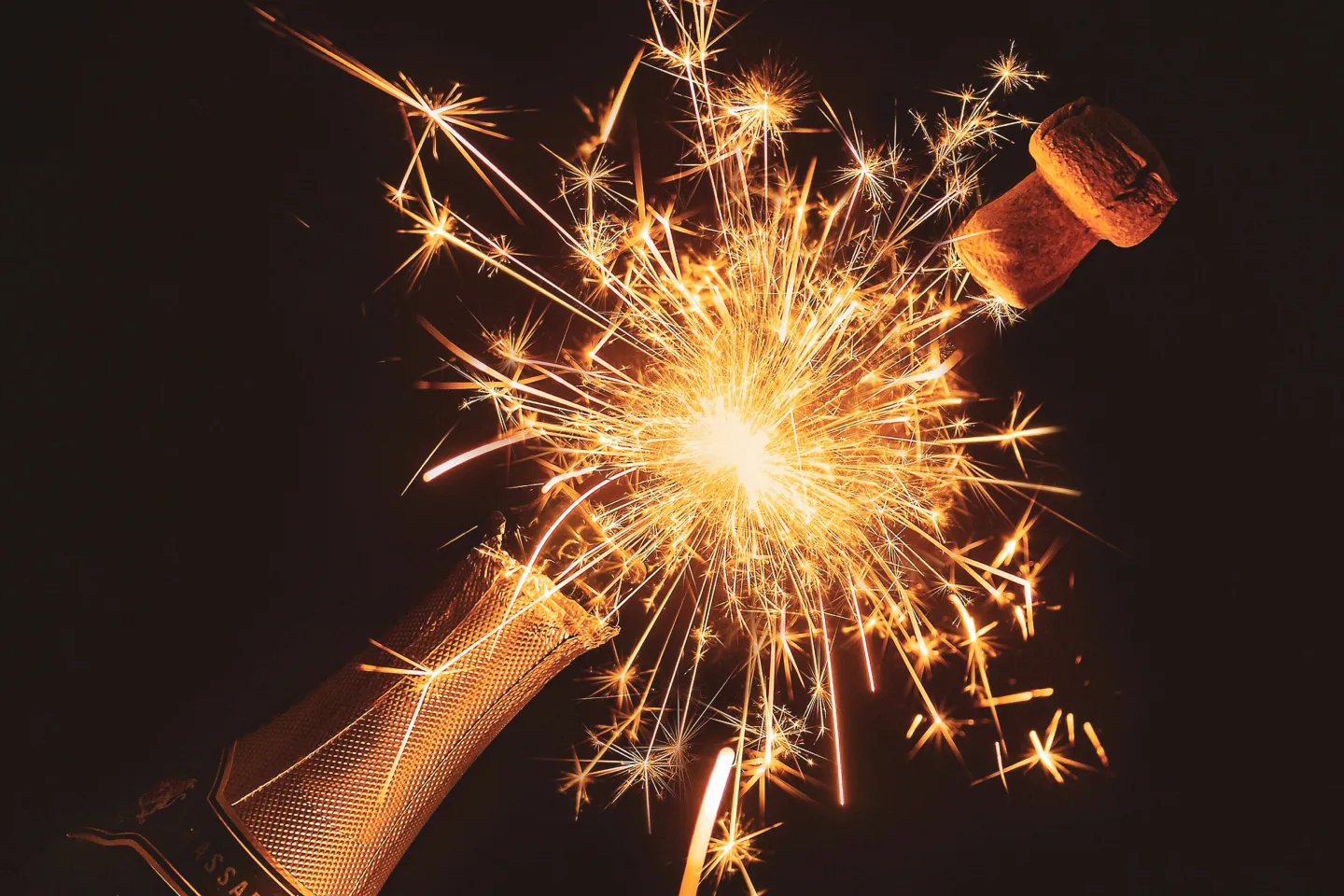 Champagne bottle with a sparkling fireworks effect.