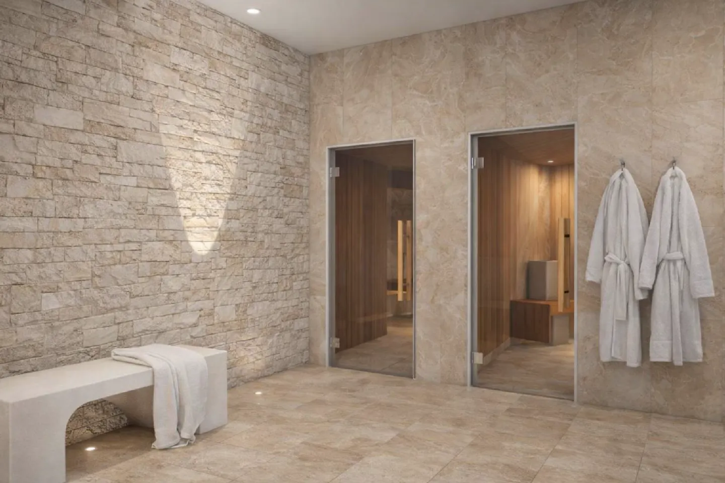 Modern spa changing room with stone walls, bench, showers, and white robes.